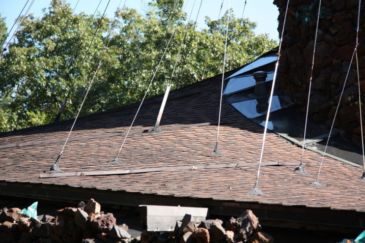 Logarithmic spiral roof suspended by airplane cables